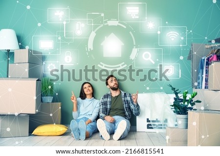 Young couple using interface of smart home automation in their new house