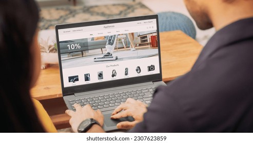 Young Couple Using Laptop to Buy Appliances From the Confort of Their Home: They are Browsing Internet, Doing Online Shopping, Choosing the Best Deal of Sale on Websites, Discussing the Decision