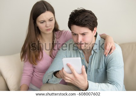 Young couple using tablet, broken, troubles with connection, financial problems, guy playing games, negative and upset, reading bad news, hand on shoulder, mobile banking, insufficient funds