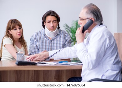 Young couple visiting old male doctor  - Powered by Shutterstock