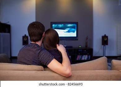 Young couple waching  movie on tv. Self isolation at home