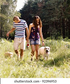 Young Couple Walking Dog