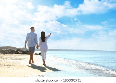 Young Couple Walking On Beach Near Sea, Back View. Honeymoon Trip