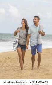 Young Couple Walking On The Beach