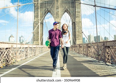 Young Couple Walking On The Brooklyn Bridge