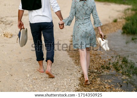 young couple walking on coast