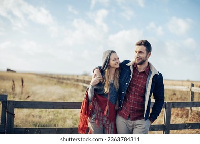 Young couple walking on a field on a farm in the countryside
