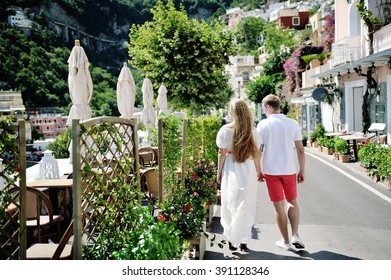 Young Couple Walking On Positano In A Sunny Day, Amalfi Coast, Italy