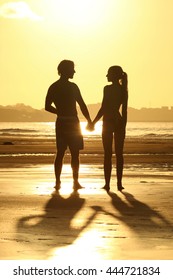 Young couple walking at sunset