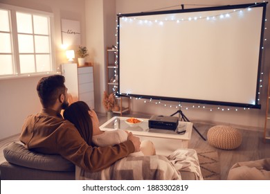 Young Couple Watching Movie At Home