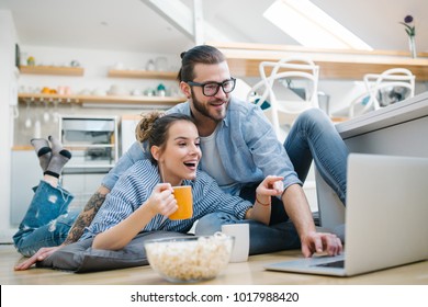 Young Couple Watching Movie On Laptop At Home