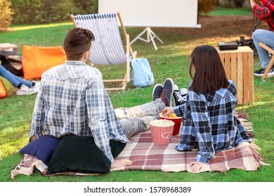 Young Couple Watching Movie In Outdoor Cinema