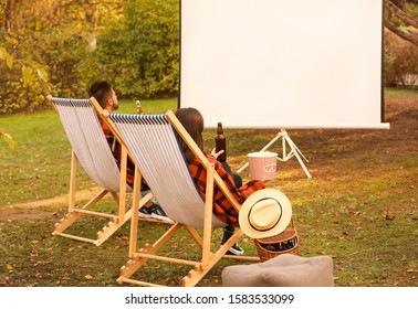 Young Couple Watching Movie In Outdoor Cinema