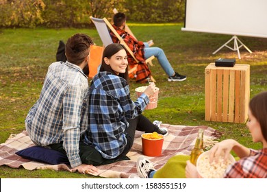 Young Couple Watching Movie In Outdoor Cinema