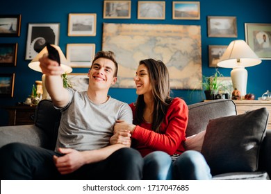 Young Couple Watching Television Together.Favorite Series New Episode.Excited About New Film.Couple Activities At Home During Quarantine Lockdown.Binge Watching Movies Marathon.TV Streaming Service