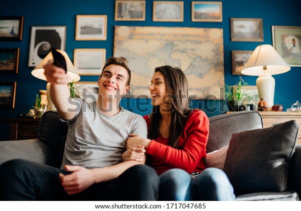 Young couple watching television\
together.Favorite series new episode.Excited about new film.Couple\
activities at home during quarantine lockdown.Binge watching movies\
marathon.TV Streaming\
service