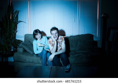 Young Couple Watching Tv, Laughing