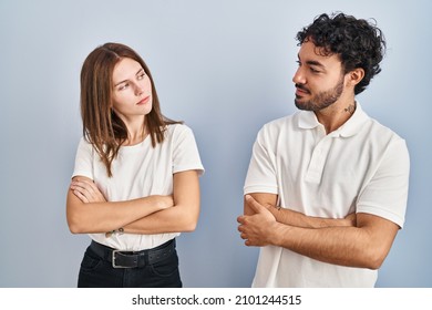 Young Couple Wearing Casual Clothes Standing Together Looking To The Side With Arms Crossed Convinced And Confident 