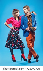 Young couple wearing colorful old-fashion clothes in pinup style