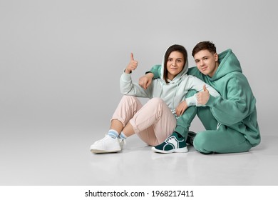 Young Couple Wearing Mint Green Casual Hoodie