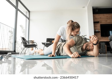 Young couple working out and practicing yoga in the comfort of their own home.	
 - Shutterstock ID 2366450417