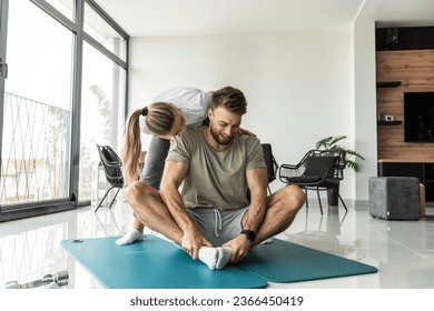 Young couple working out and practicing yoga in the comfort of their own home.	
 - Shutterstock ID 2366450419