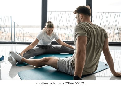 Young couple working out and practicing yoga in the comfort of their own home.	
 - Shutterstock ID 2366450421
