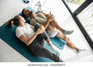 Young couple working out and practicing yoga in the comfort of their own home.	
 - Shutterstock ID 2366450427