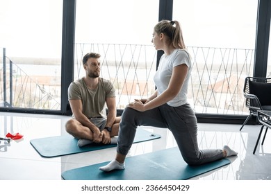 Young couple working out and practicing yoga in the comfort of their own home.	
 - Shutterstock ID 2366450429