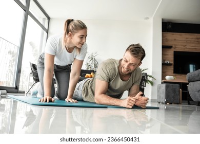 Young couple working out and practicing yoga in the comfort of their own home.	
 - Shutterstock ID 2366450431