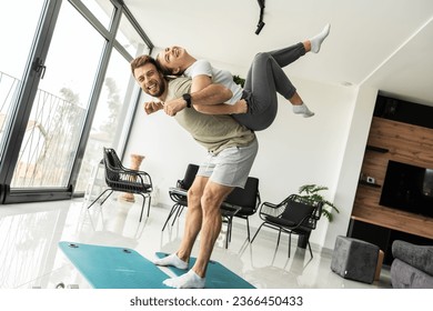 Young couple working out and practicing yoga in the comfort of their own home.	
 - Shutterstock ID 2366450433