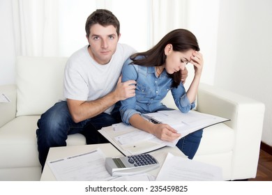 young couple worried home in stress husband comforting wife accounting debt bills bank papers expenses and payments feeling desperate in bad financial situation - Shutterstock ID 235459825