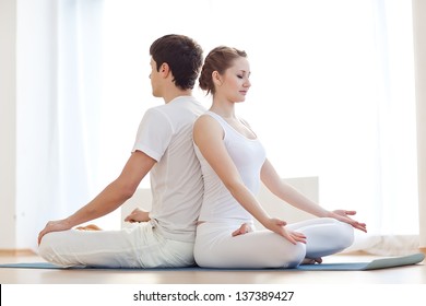 Young Couple In Yoga Pose