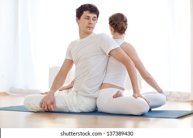 Young Couple In Yoga Pose