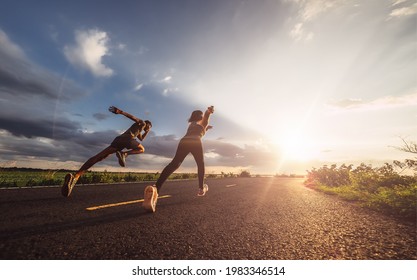 Young couples running sprinting at sunset times. Fit runner fitness runner during outdoor workout. - Powered by Shutterstock