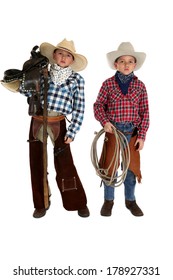 Young cowboys holding a saddle and rope