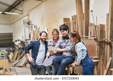 Young Craftsmen Start-up Team With Laptop Computer In The Carpentry Workshop