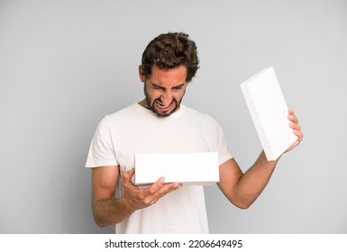 Young Crazy Bearded And Expressive Man Holding Blank Packaging Box