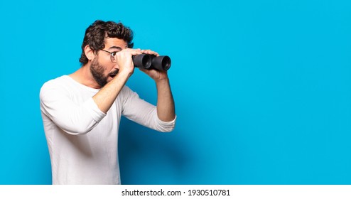 Young Crazy Bearded Man With Binoculars