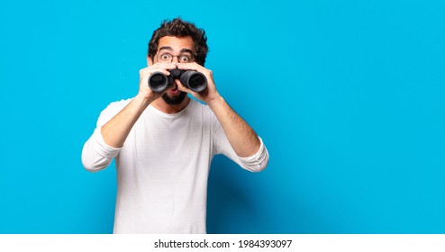 Young Crazy Bearded Man With Binoculars