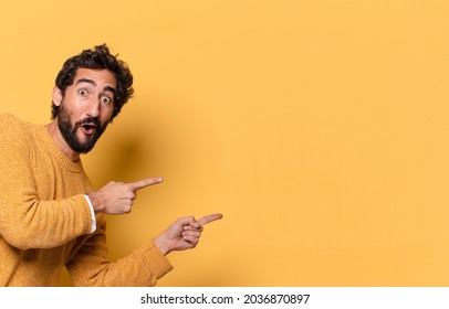 young crazy bearded man expressing with a copy space.