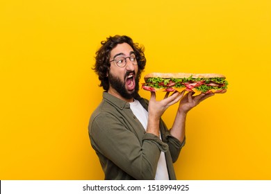 young crazy bearded man with a giant sandwich. - Powered by Shutterstock