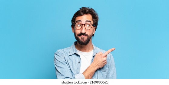 young crazy bearded man. pointing gesture confused expression - Shutterstock ID 2169980061