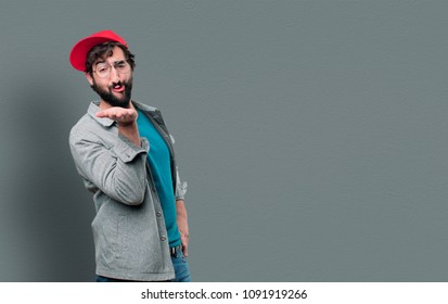 Young Crazy Man With Beard And Red Cap And Sending A Kiss