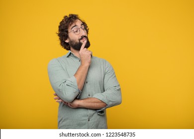 young crazy man With a confused and thoughtful look, looking sideways, thinking and wondering between different options. - Shutterstock ID 1223548735