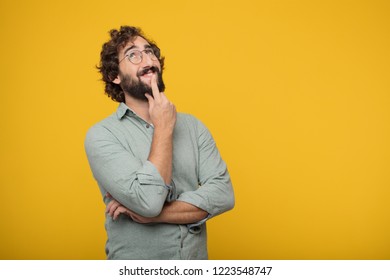 young crazy man With a confused and thoughtful look, looking sideways, thinking and wondering between different options. - Shutterstock ID 1223548747