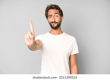 young crazy man smiling proudly and confidently making number one pose triumphantly, feeling like a leader - Powered by Shutterstock