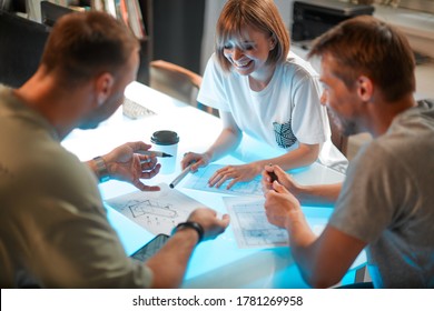 Young creative designers developing interior project in modern office. Photography for advertising design services