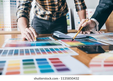 Young creative team having a meeting in creative office, Architectural drawing with work tools and accessories, Color swatch samples chart for selection coloring. - Powered by Shutterstock