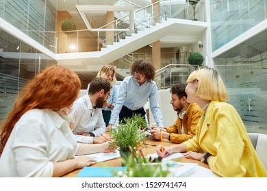 Young Creative Team Of Talented People Solve Work Issues In Modern Office, Work Hard In Good Mood Not Looking At Camera, Horizontal Shot